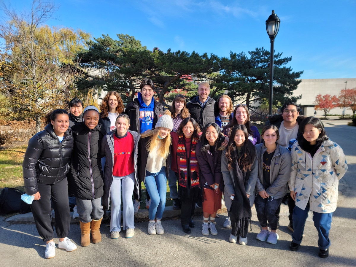 Photo of Professor Patty Loew and her students posing outside the McCormick Foundation Center